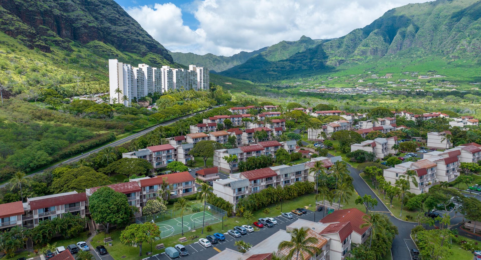 An aerial view of a residential area with mountains in the background.