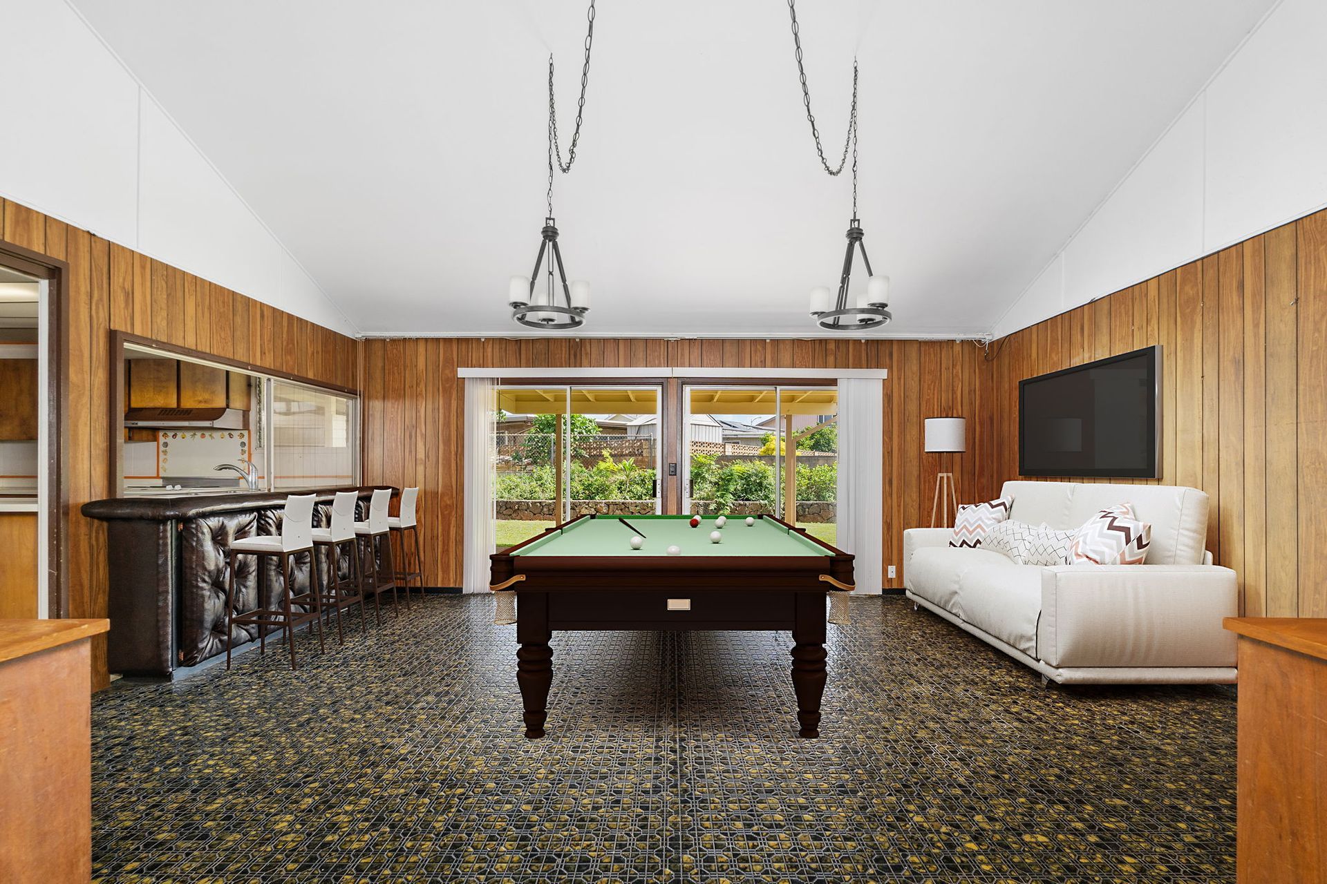 A living room with a pool table and a couch