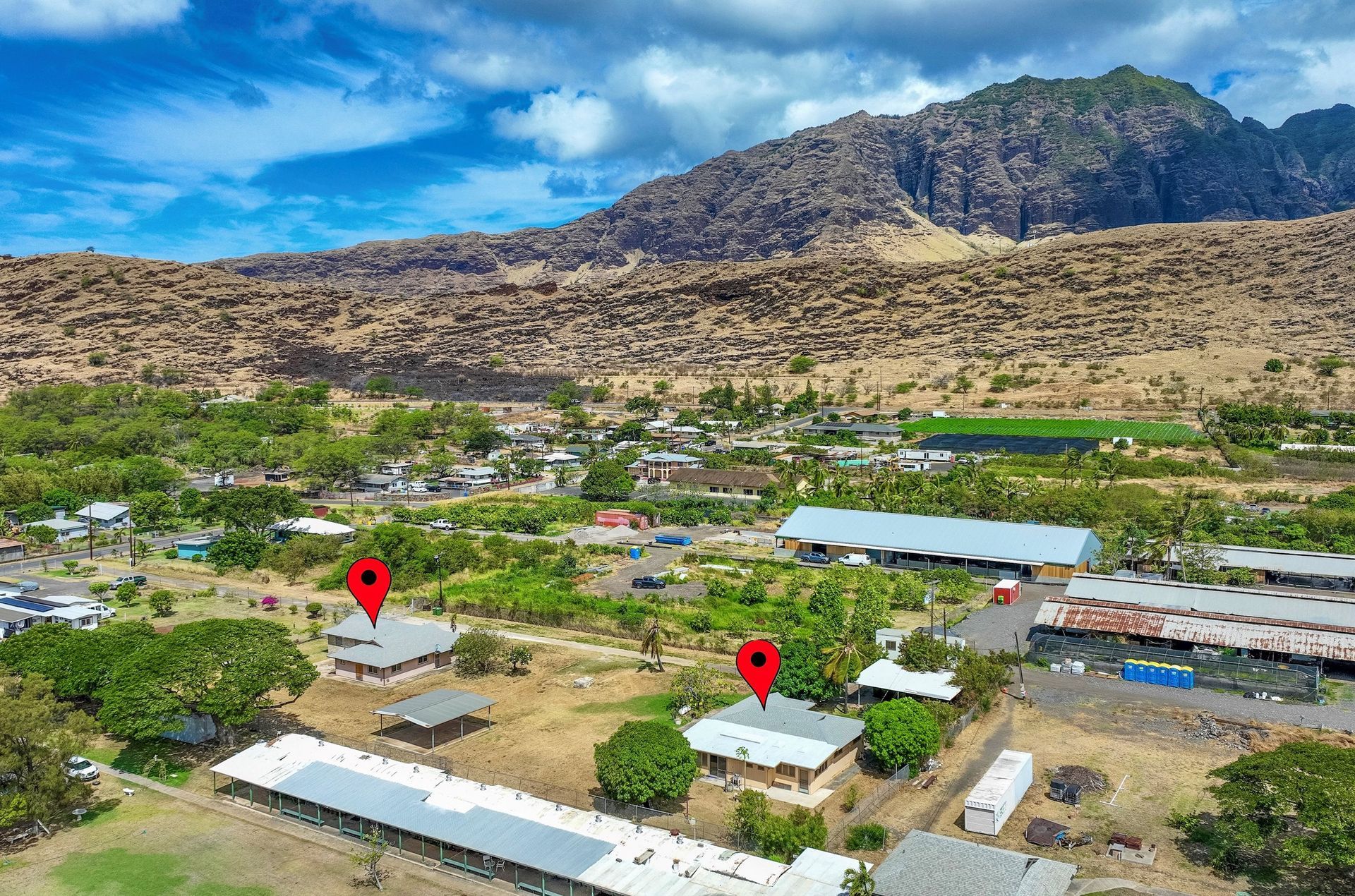 An aerial view of a small town with a mountain in the background.