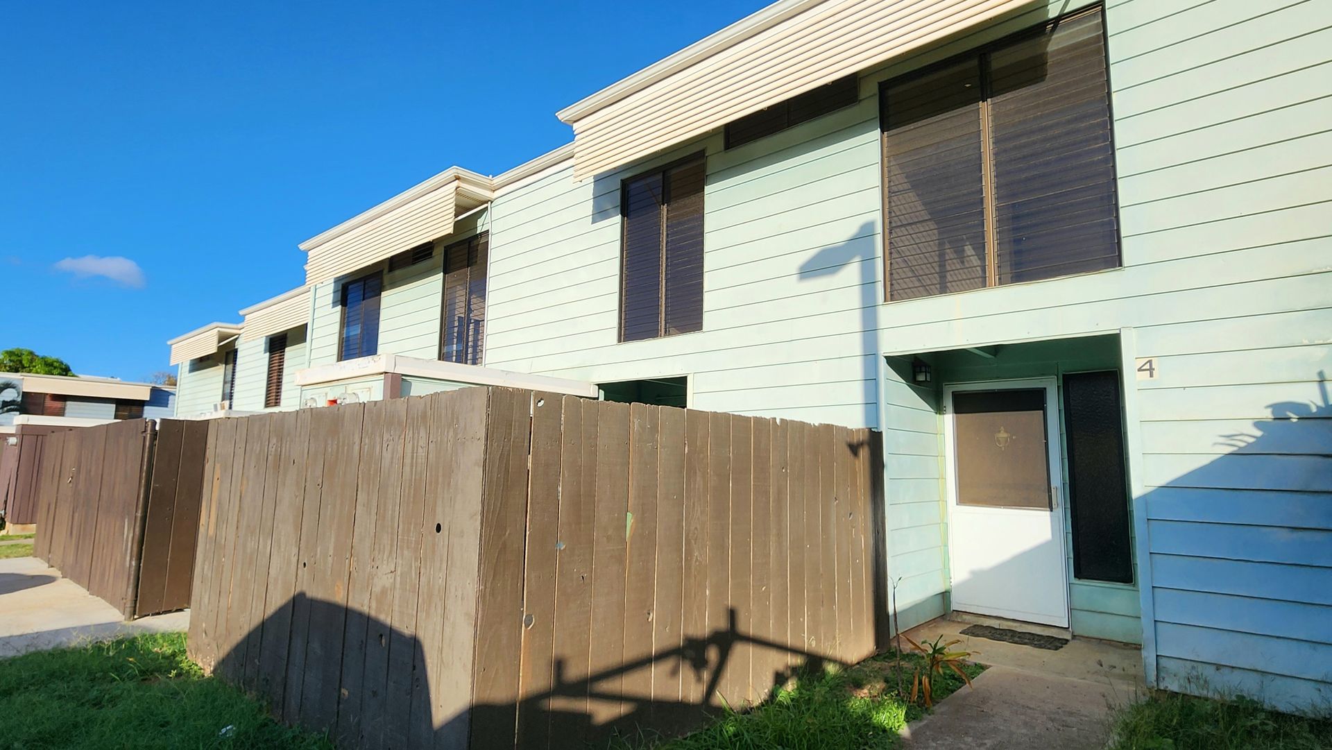 A building with a wooden fence in front of it