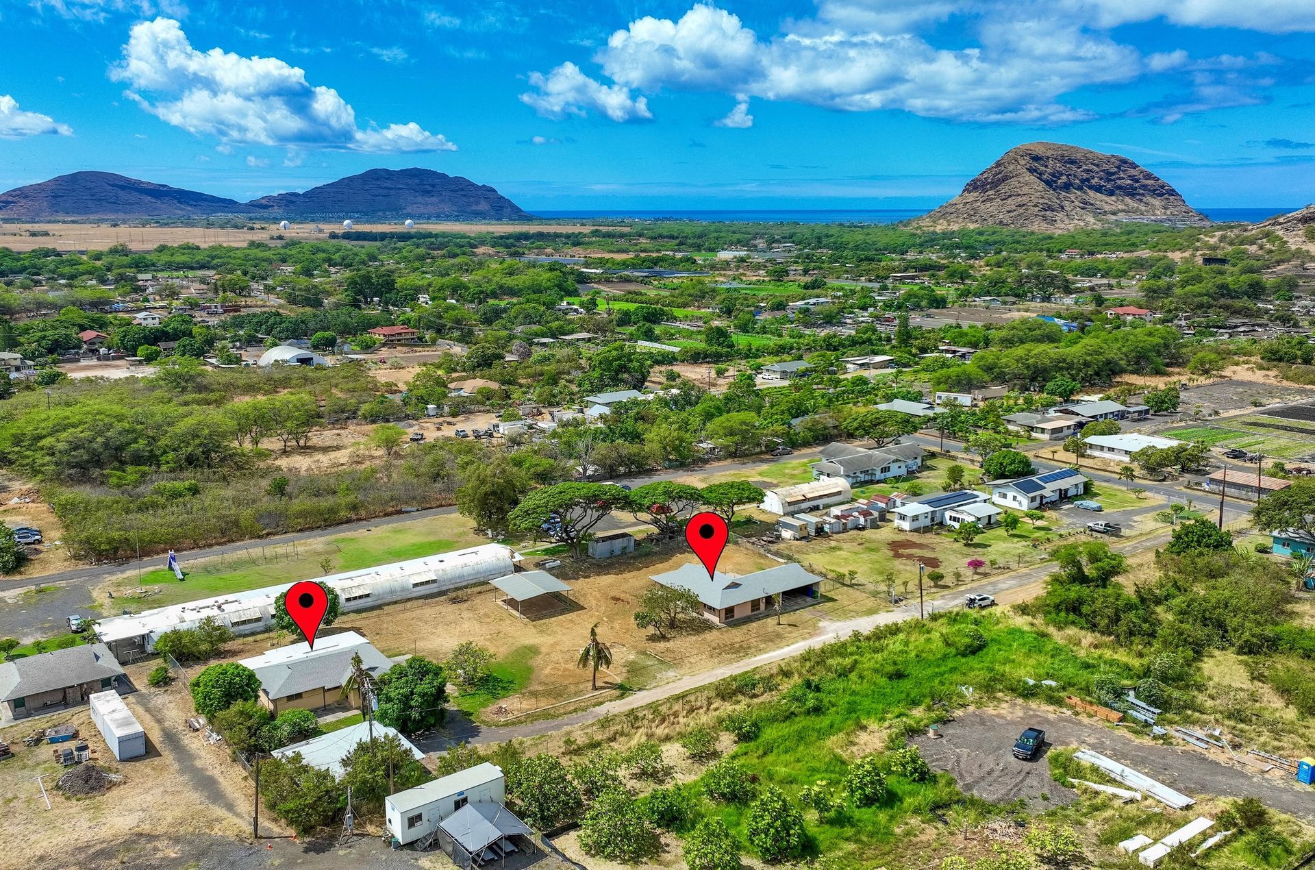 An aerial view of a small town with mountains in the background.
