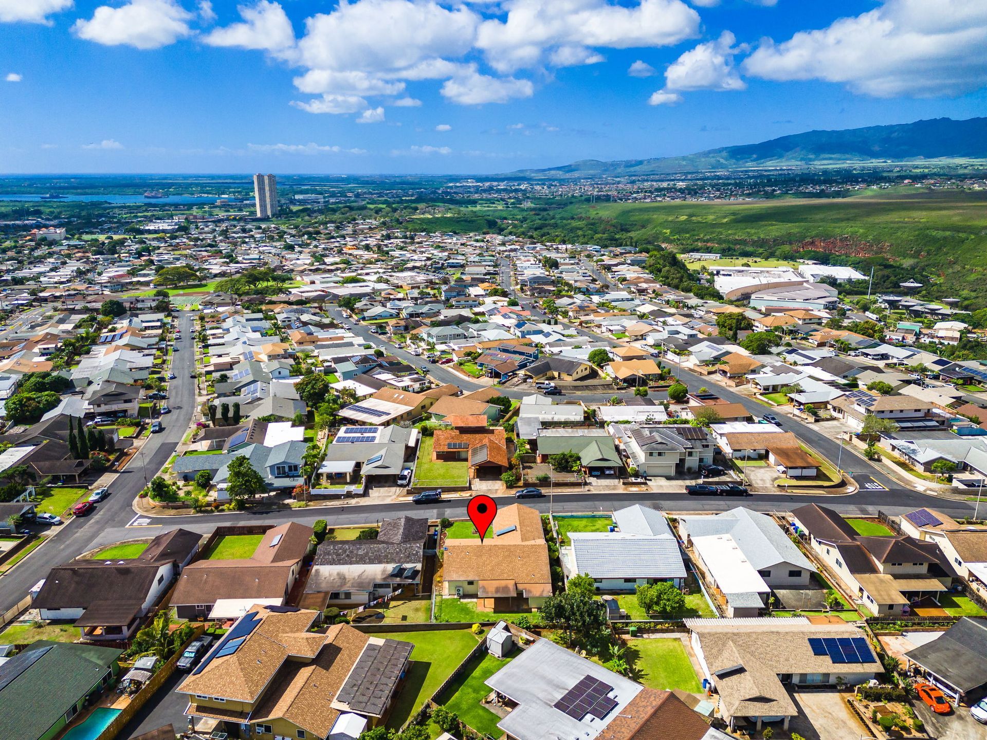 An aerial view of a residential area with a house in the middle.