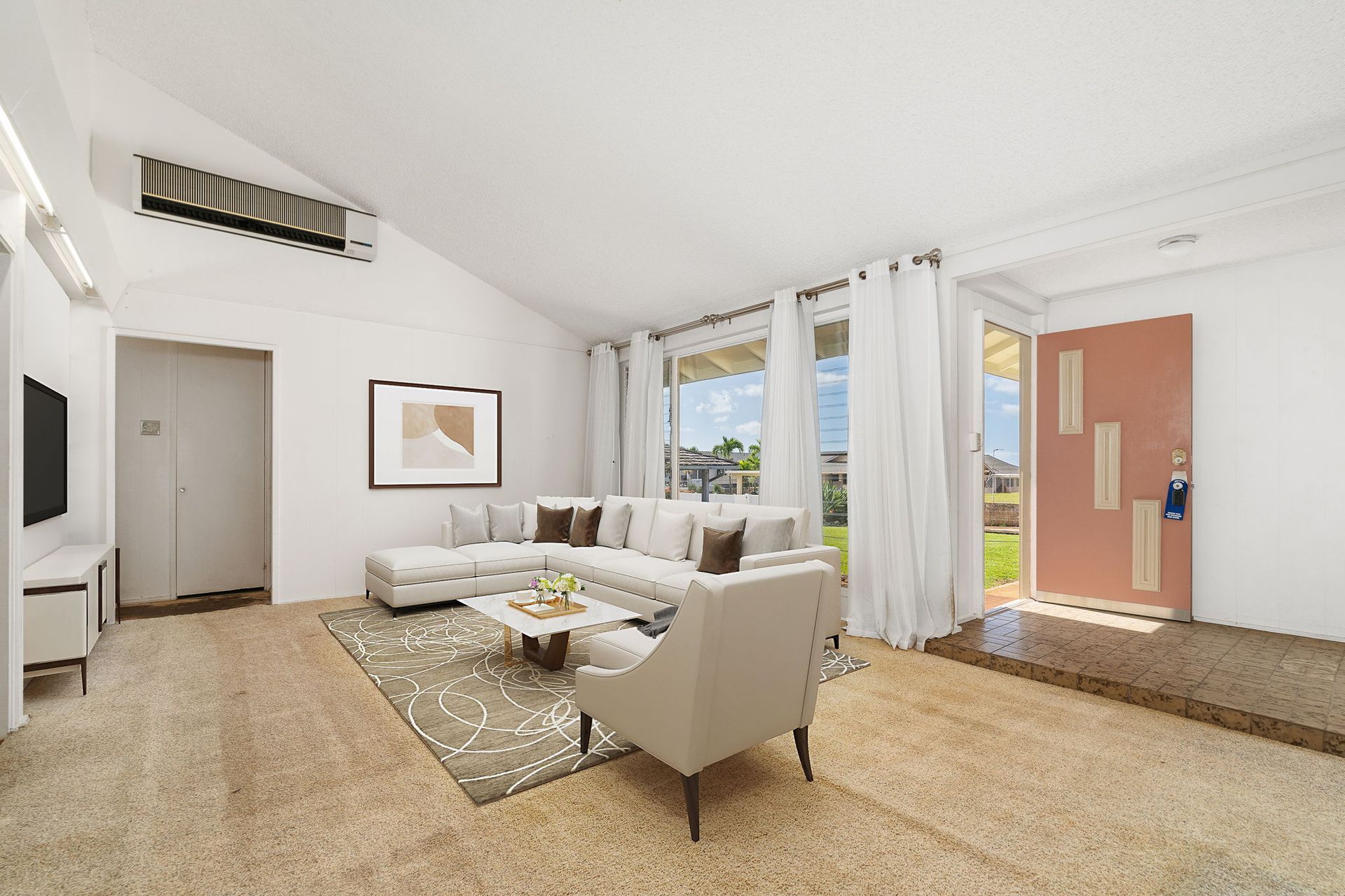 A living room with a couch , chair , table and television.