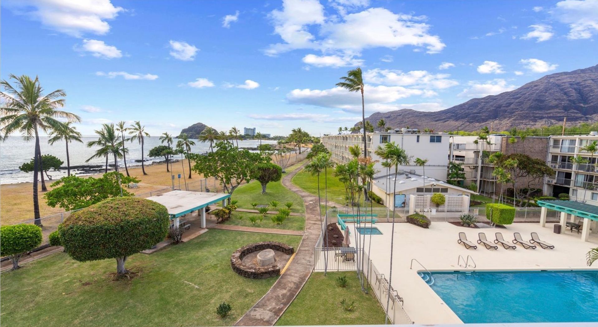 An aerial view of a swimming pool and a beach.