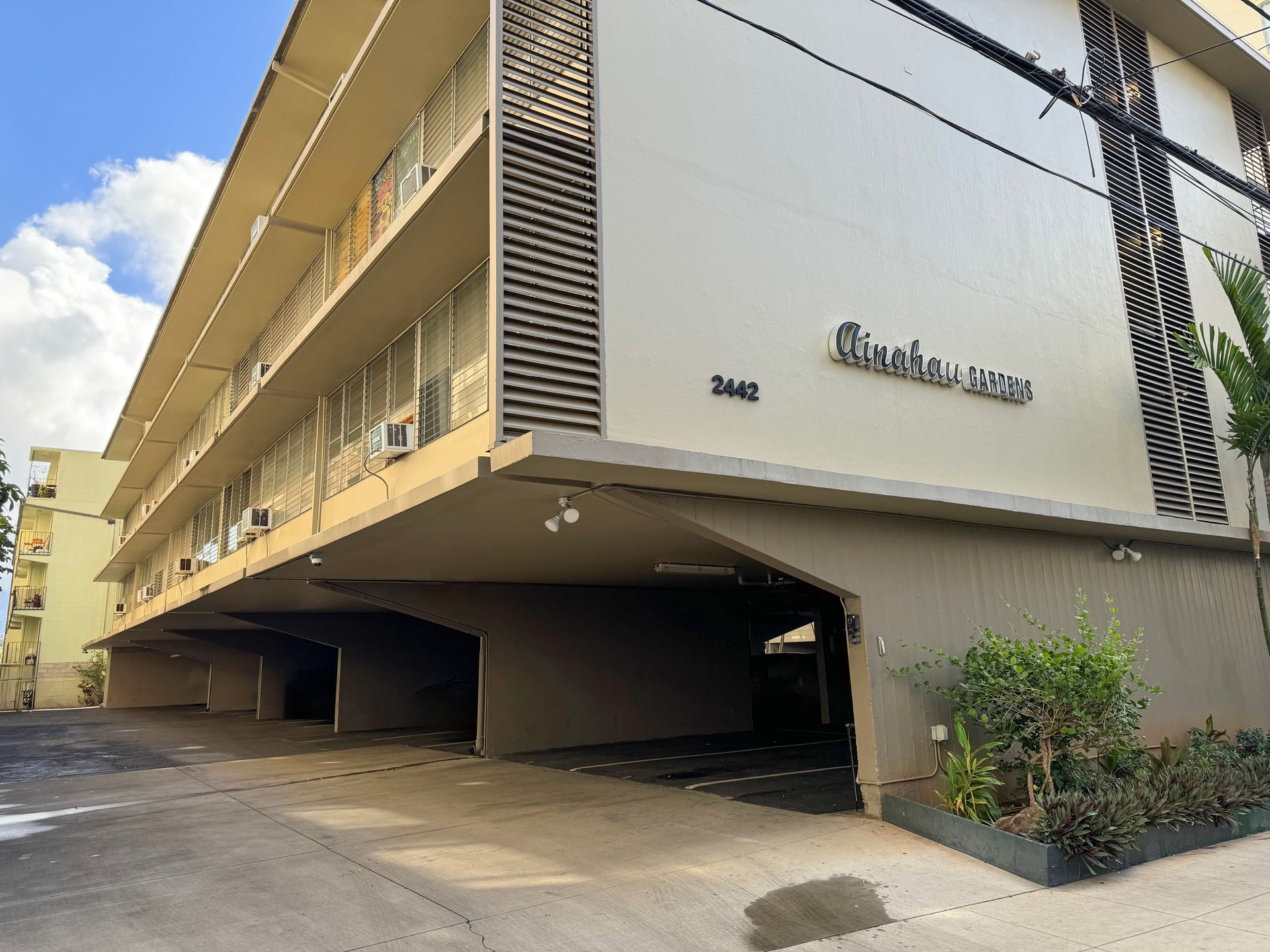 A large building with a parking garage underneath it