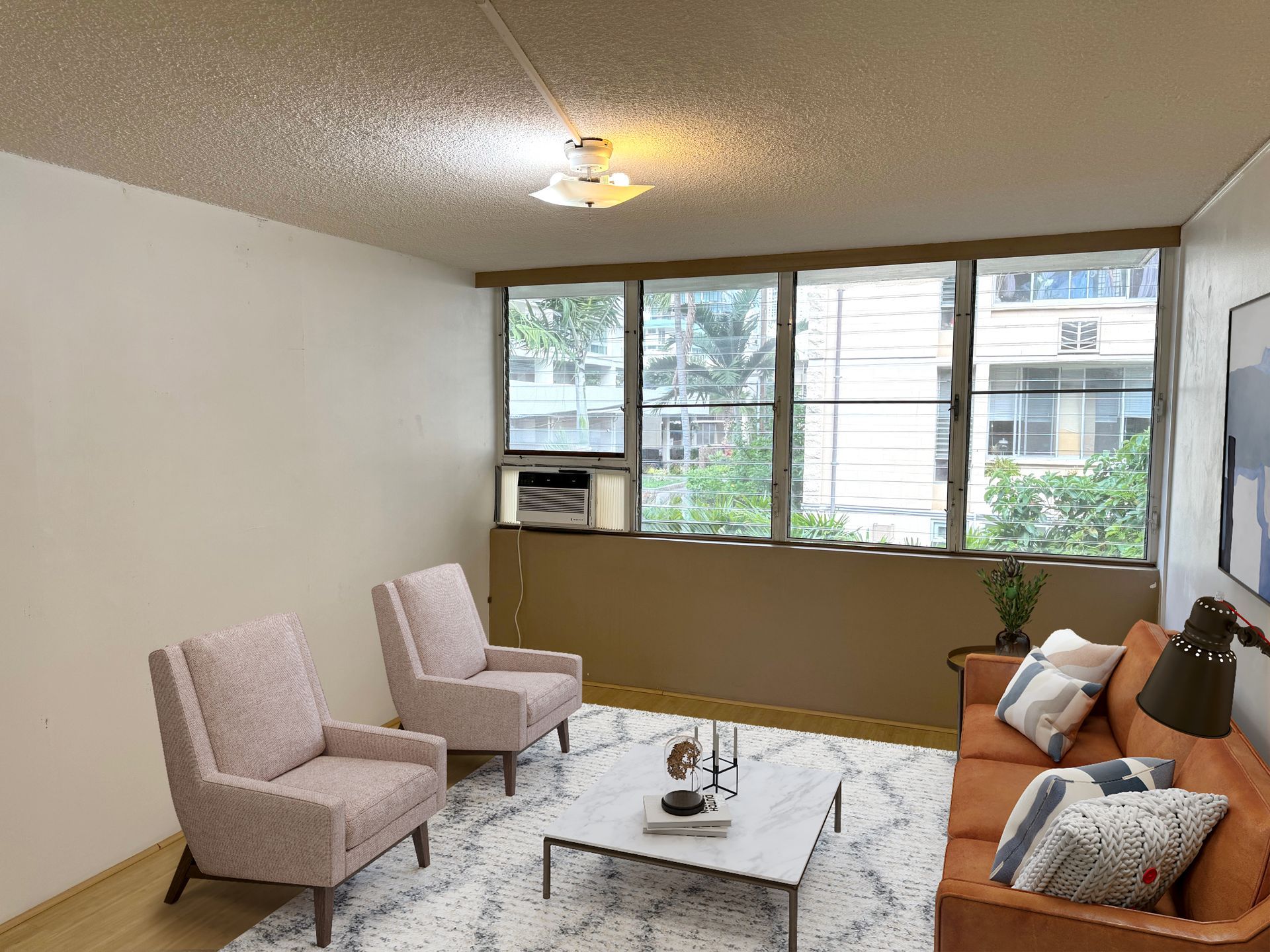 A living room with a couch , chairs , and a coffee table.