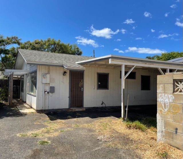 A white house with graffiti on the side of it
