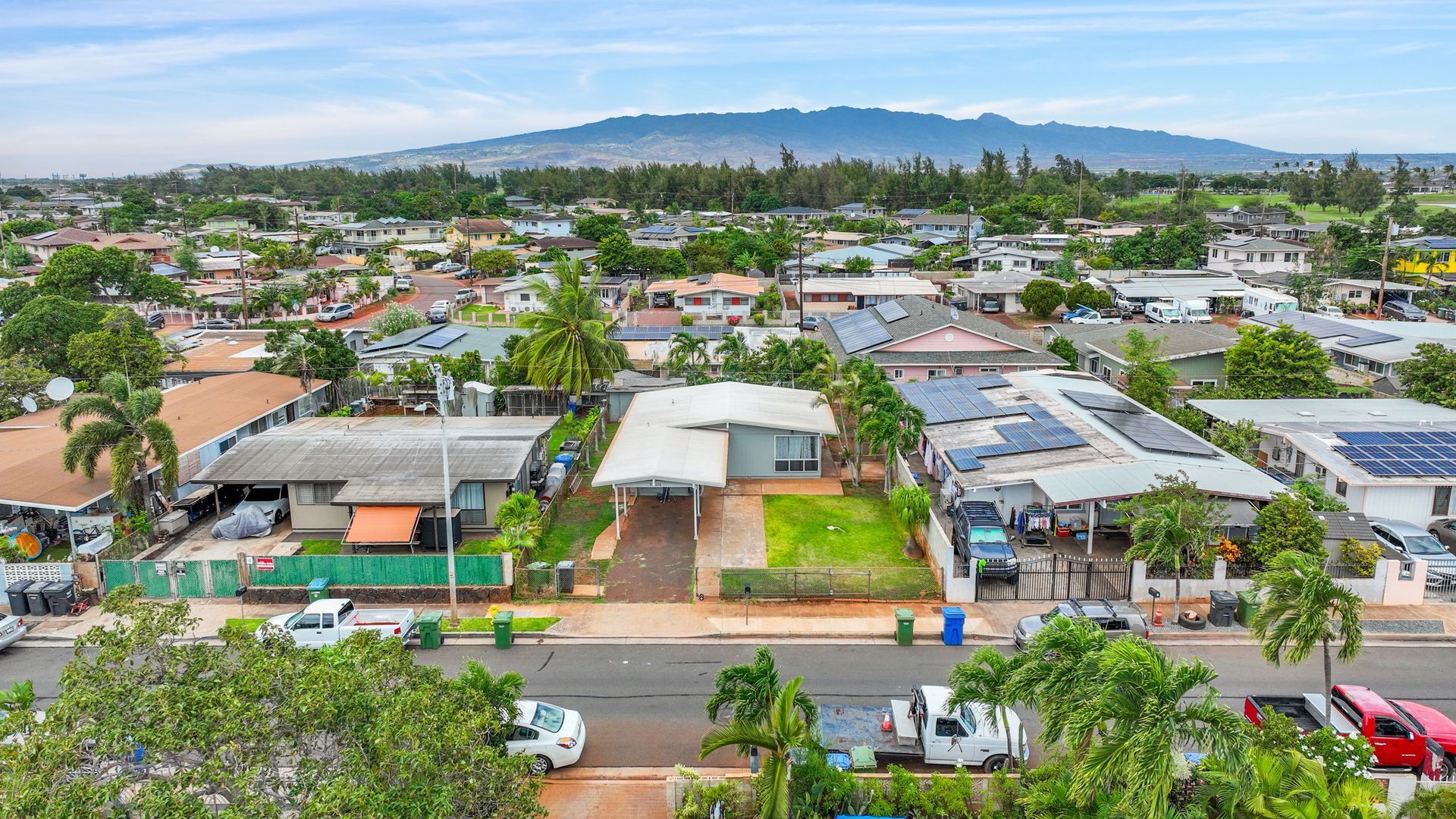 An aerial view of a residential area with a mountain in the background.