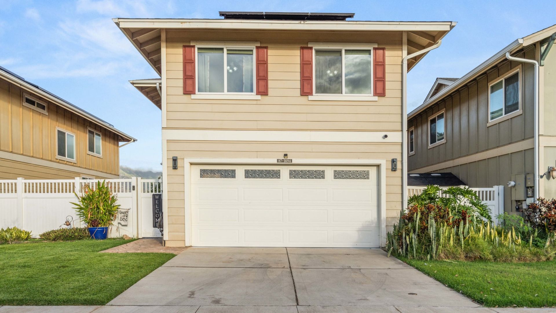 A house with a white garage door and red shutters