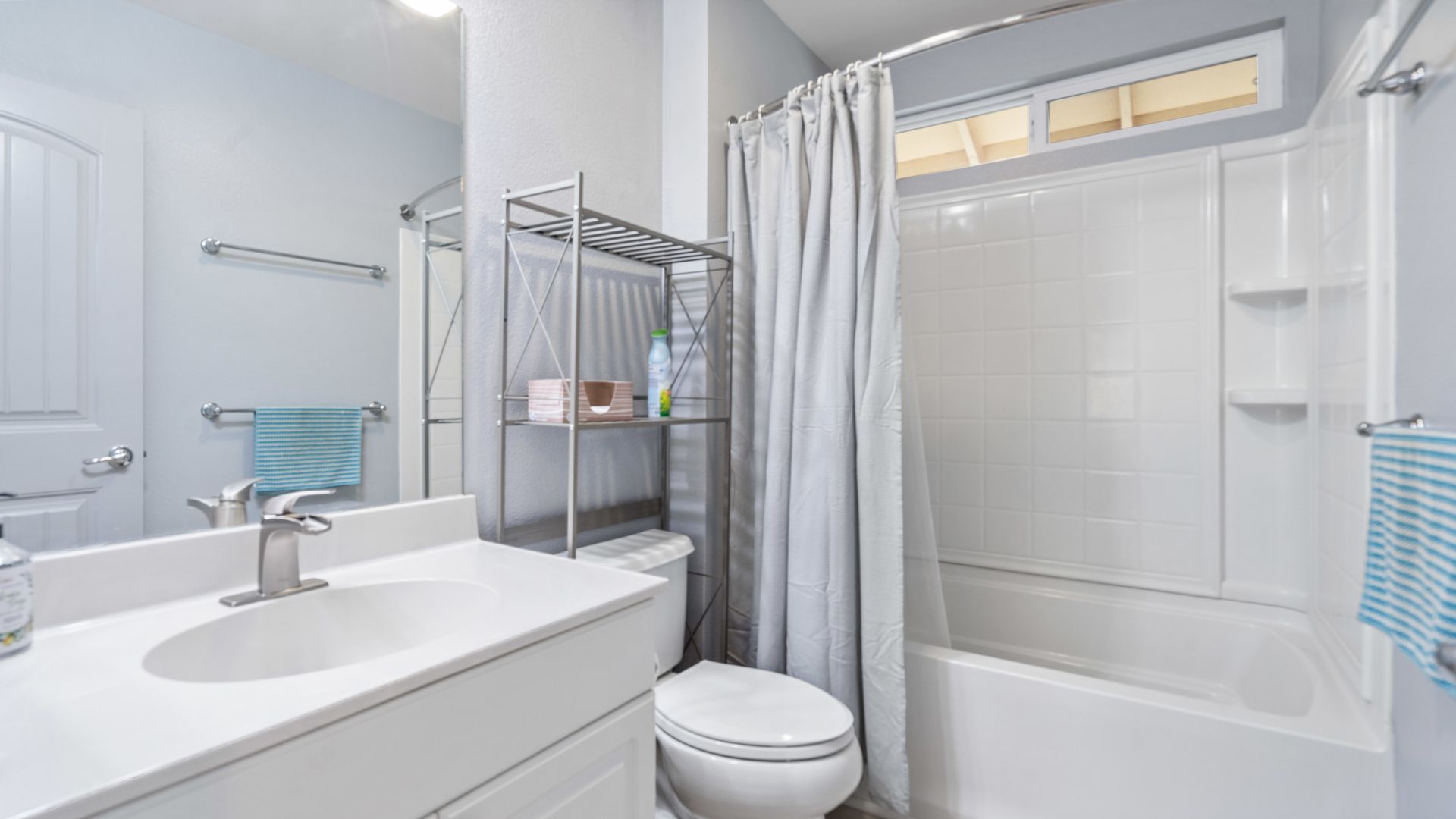 A bathroom with a toilet , sink , shower and bathtub.