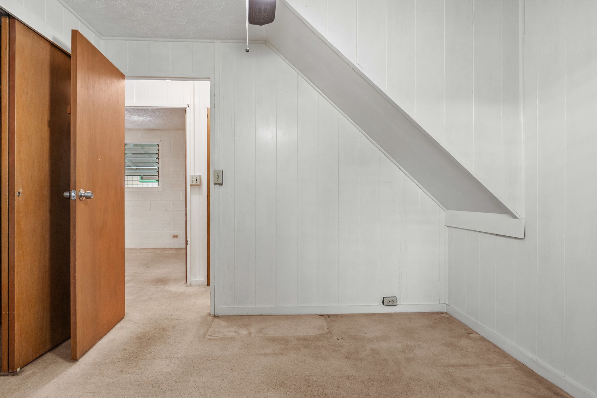 There is a staircase in the corner of the room.