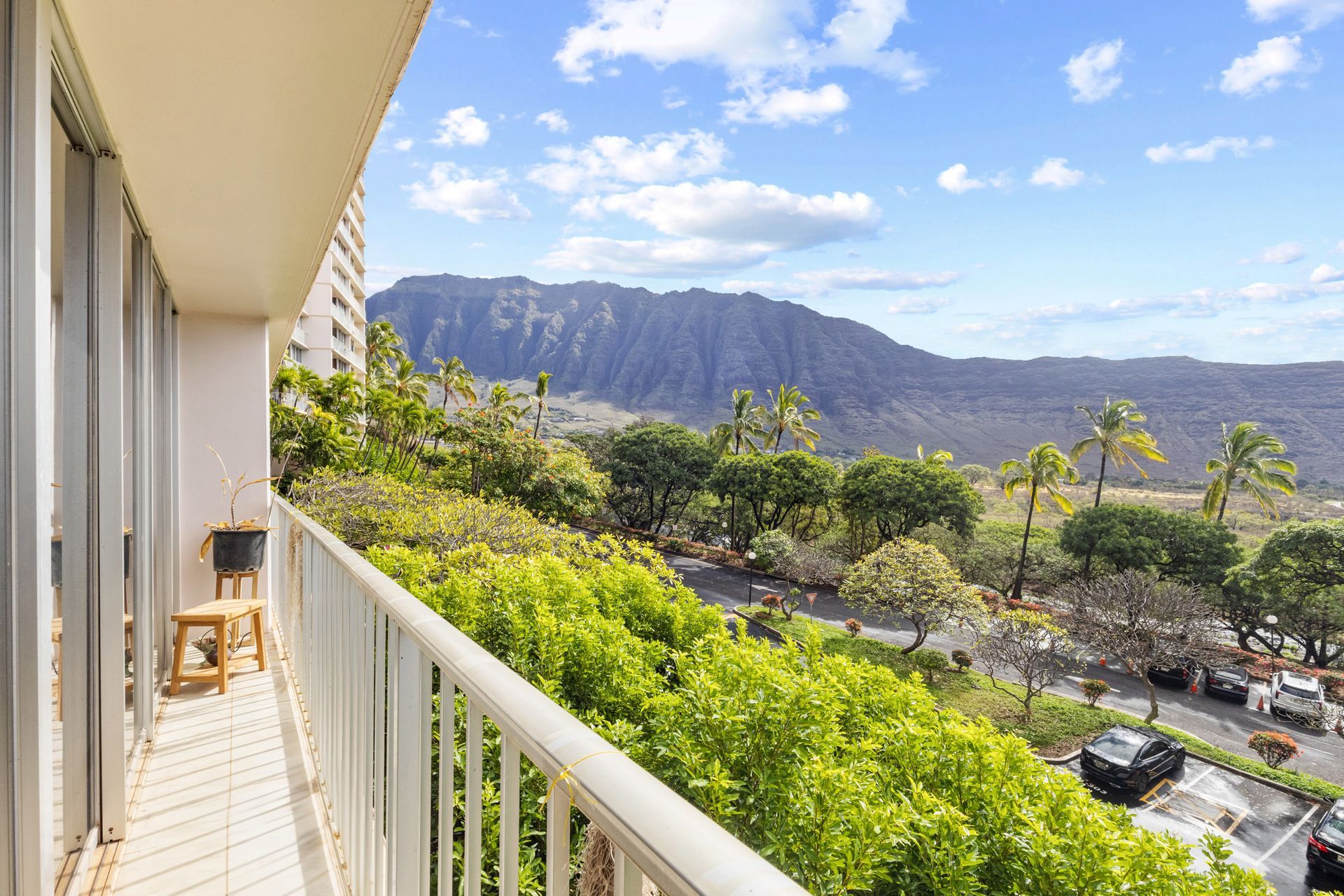 A balcony with a view of a mountain and trees.