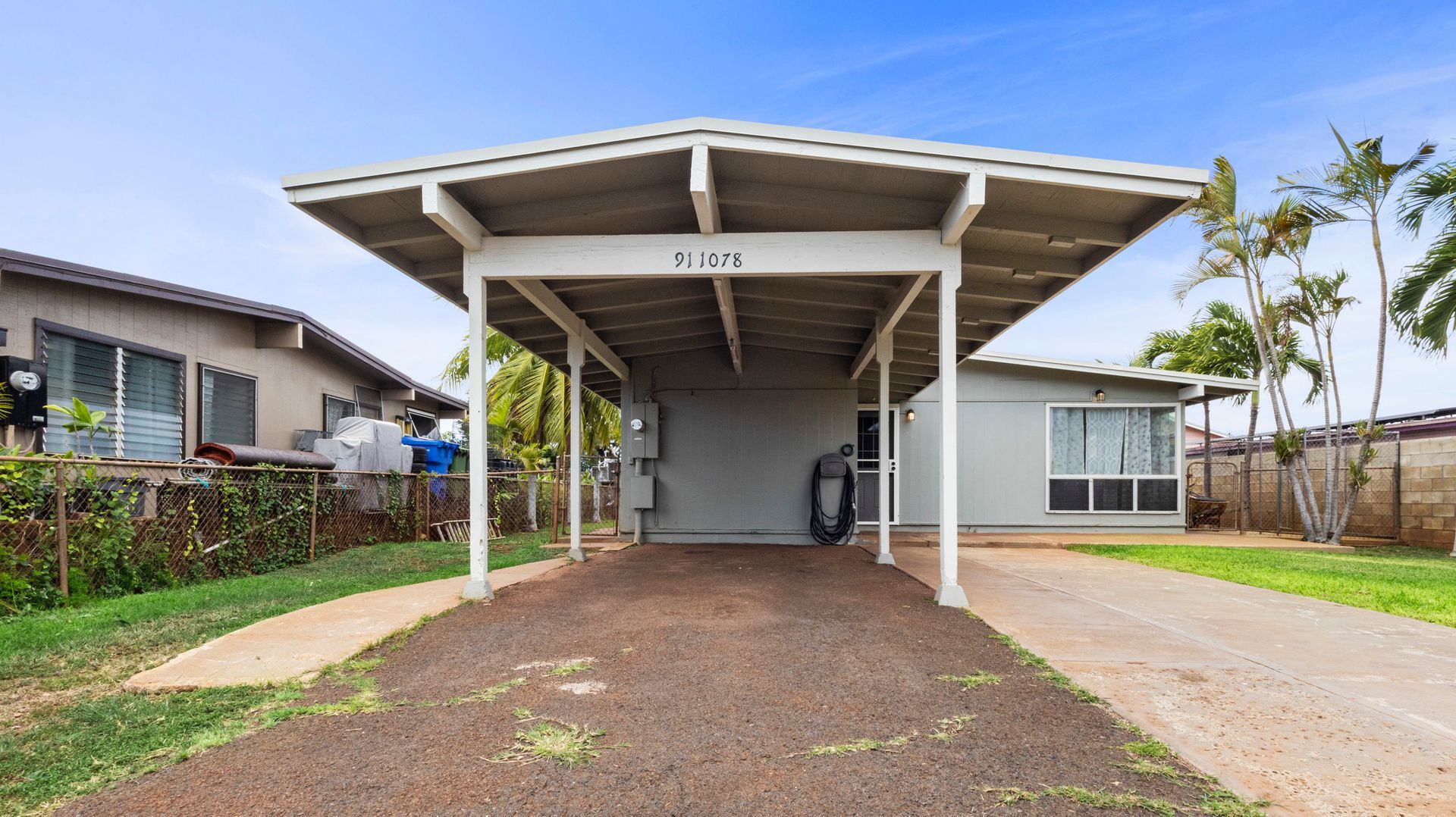 A house with a carport in front of it.