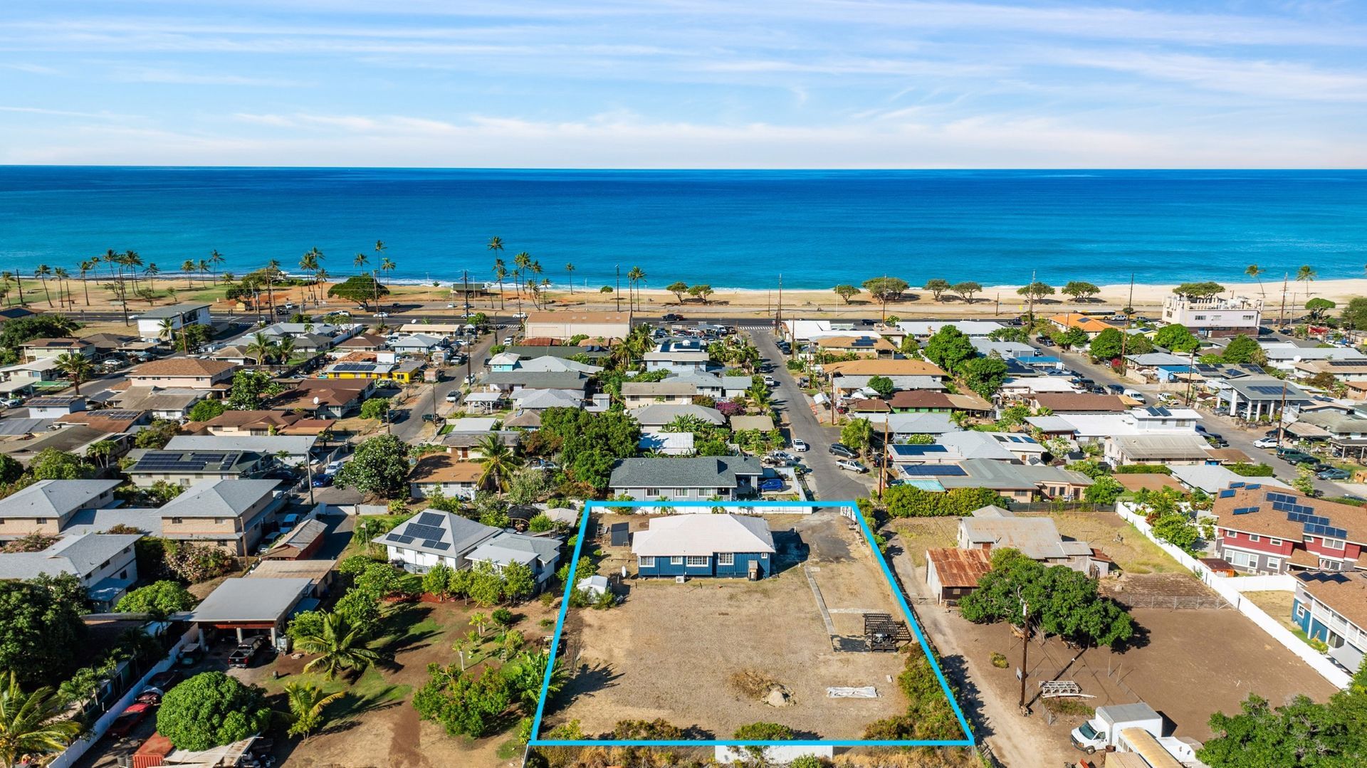 An aerial view of a residential area next to the ocean.