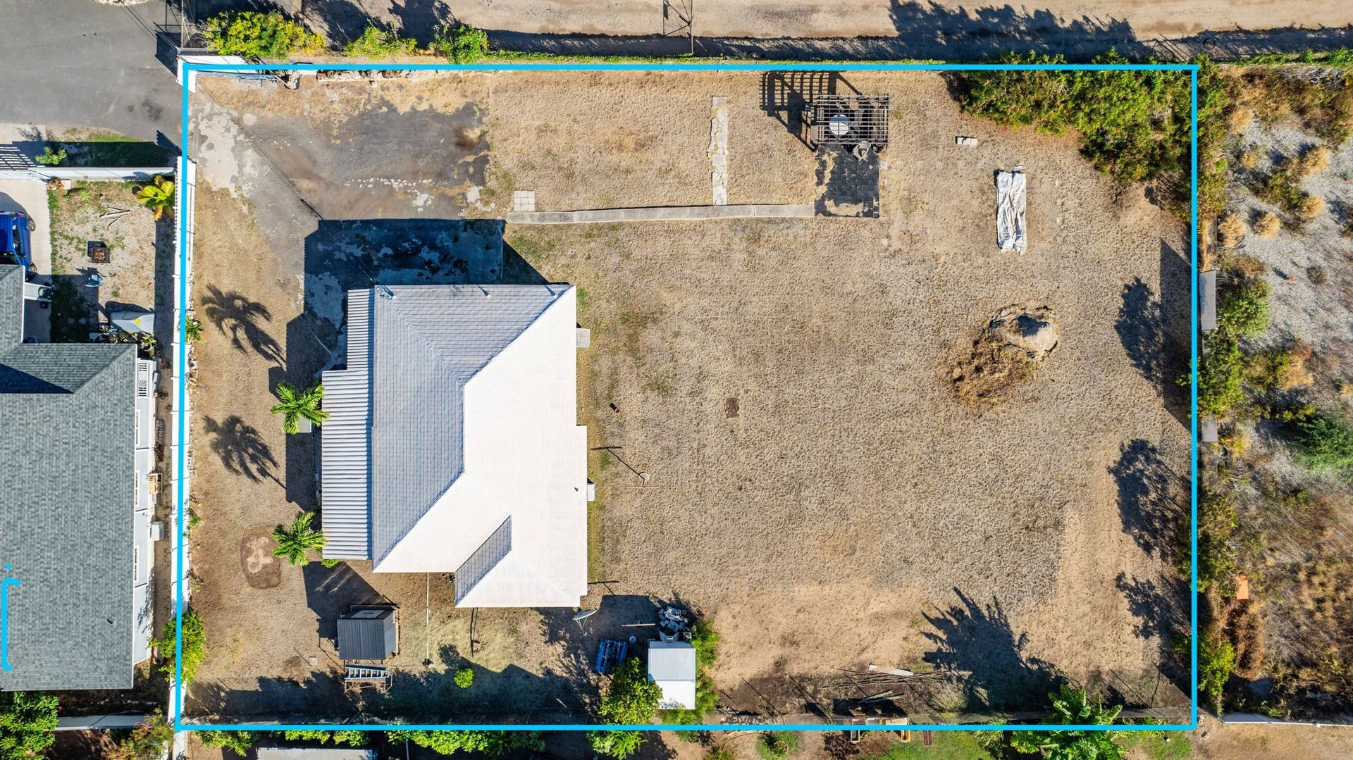 An aerial view of a house with a blue line around it.