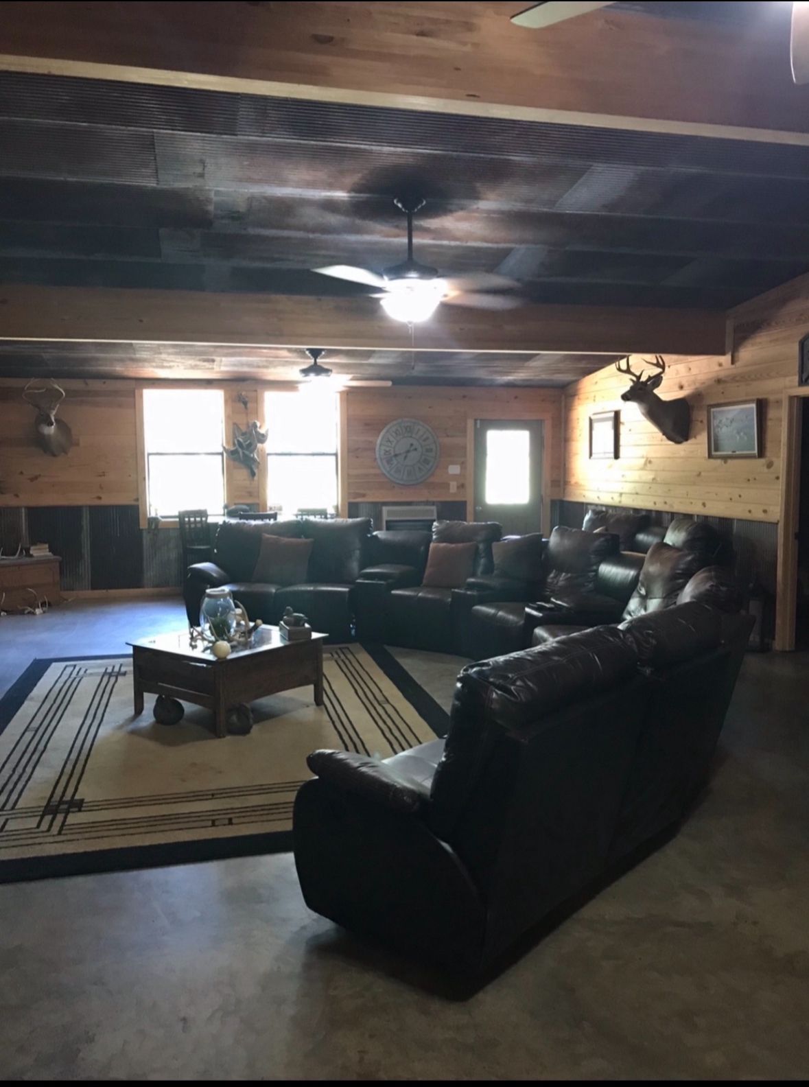 A living room filled with furniture and a ceiling fan