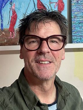 Headshot of the artist in his studio.