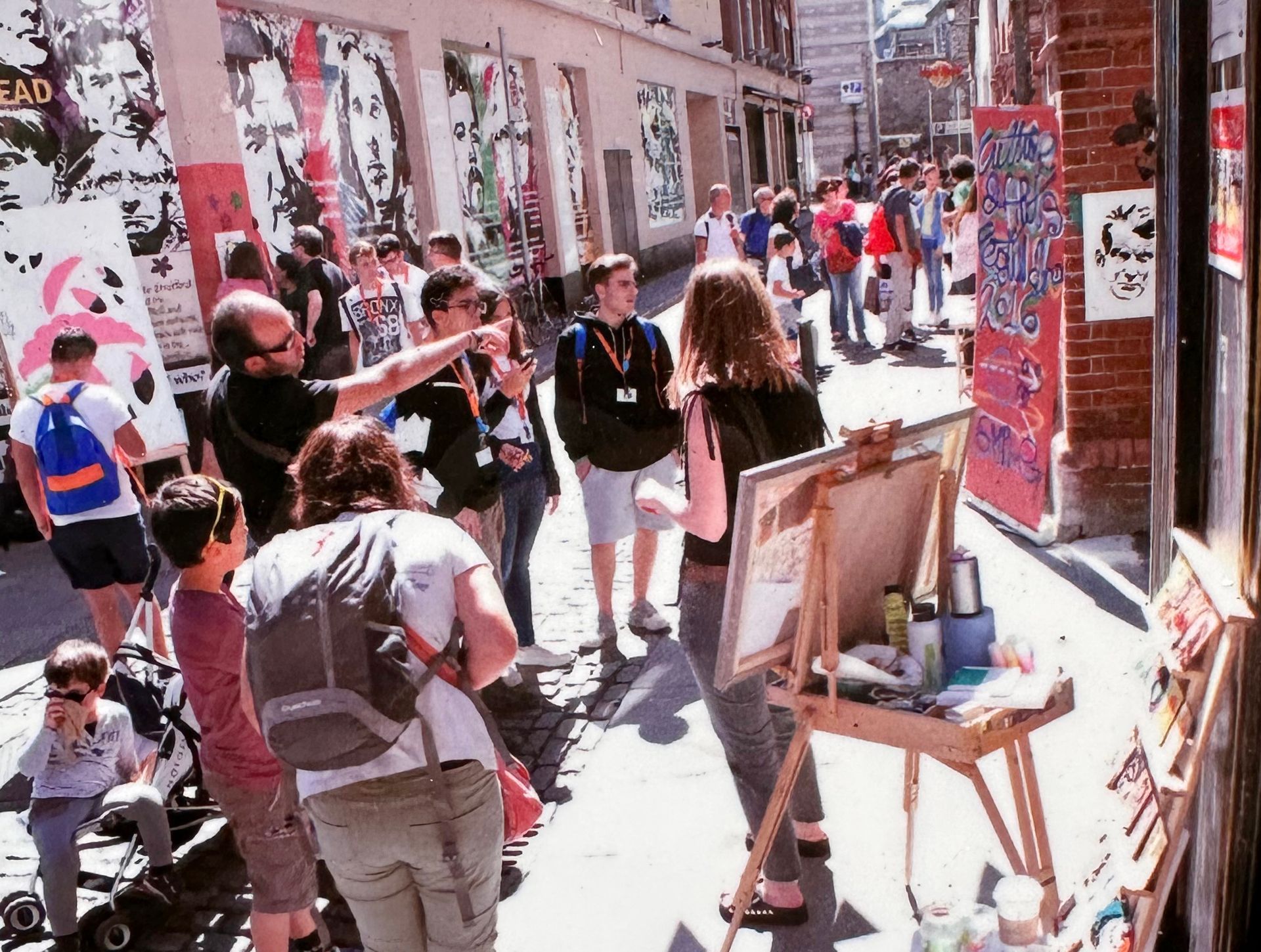 A vibrant street scene of people painting in the laneways of temple bar Dublin