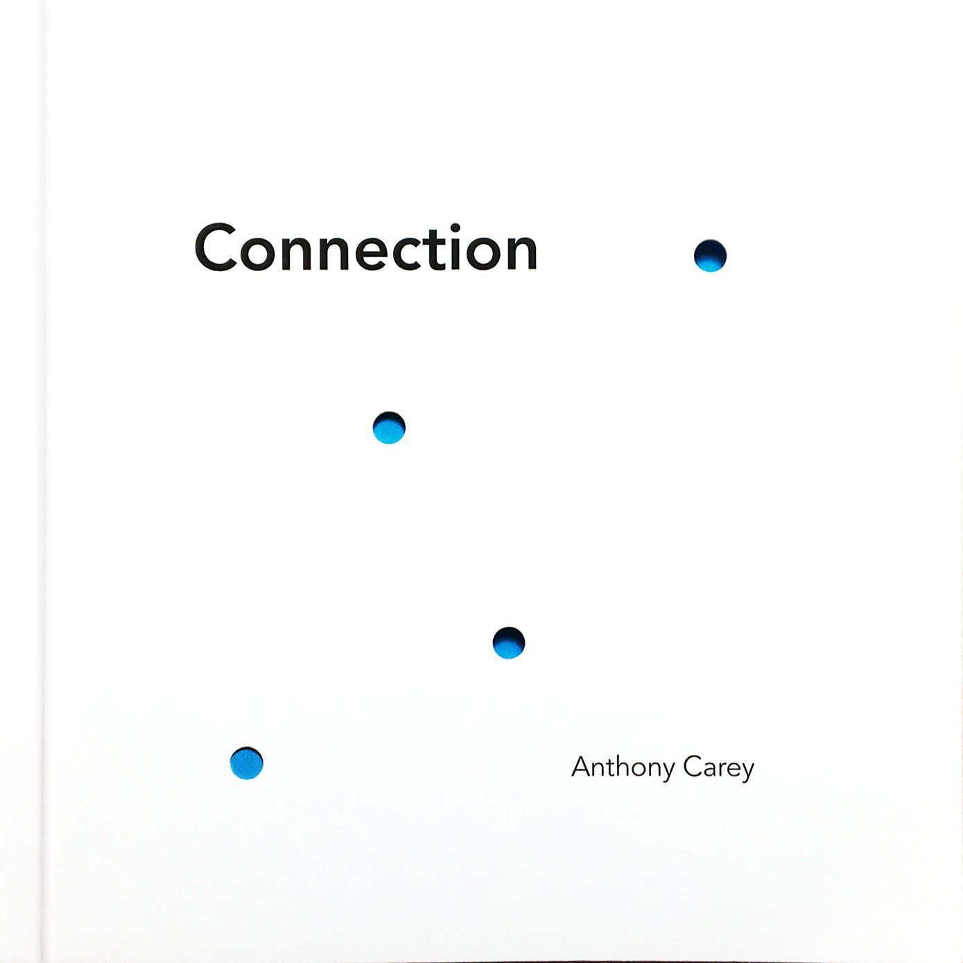 Connection book cover, white with holes punched revealing blue underneath