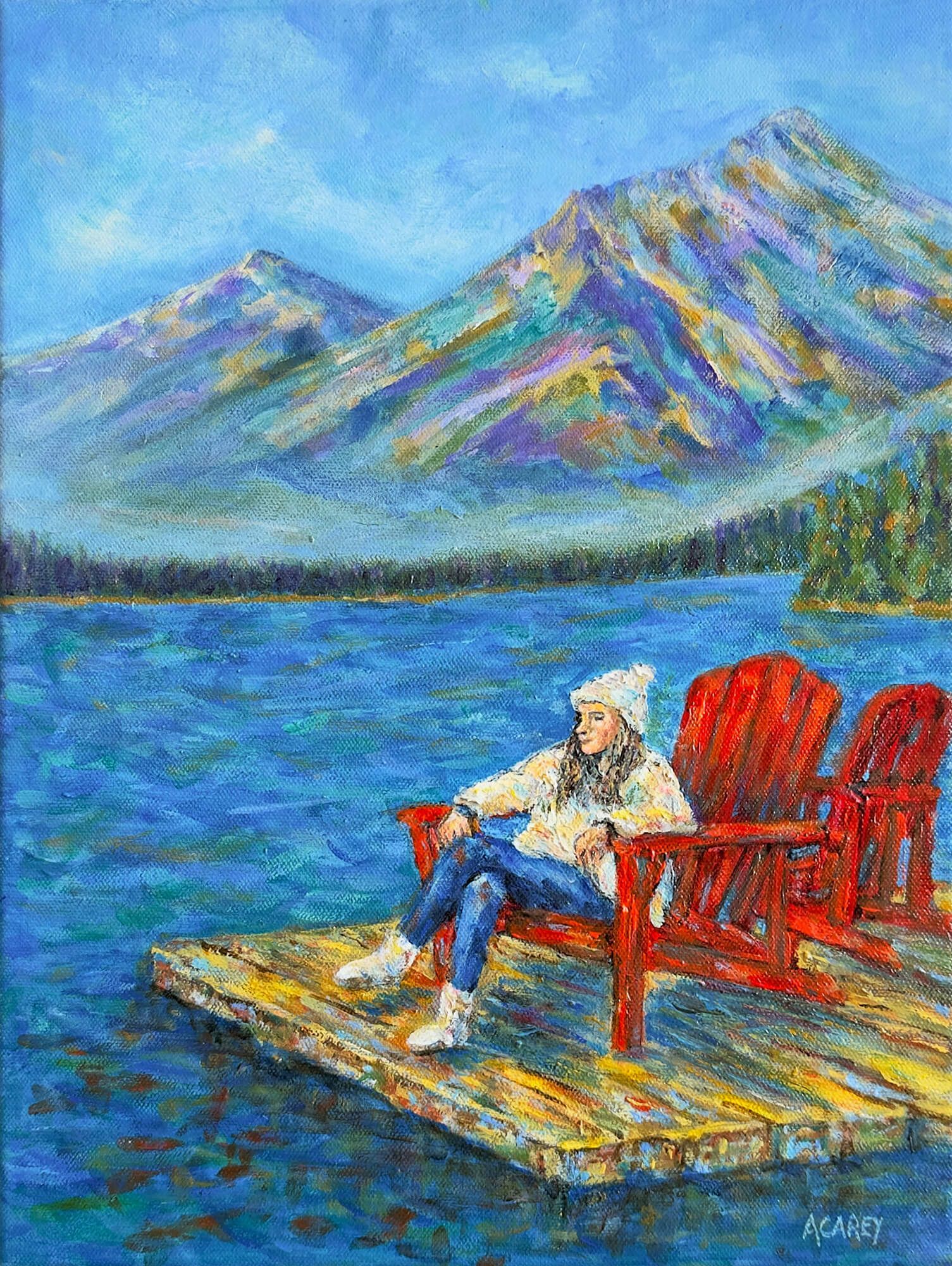 Young woman sitting on red Muskoka chairs at Pyramid Lake, Jasper, with mountains and water surrounding her.