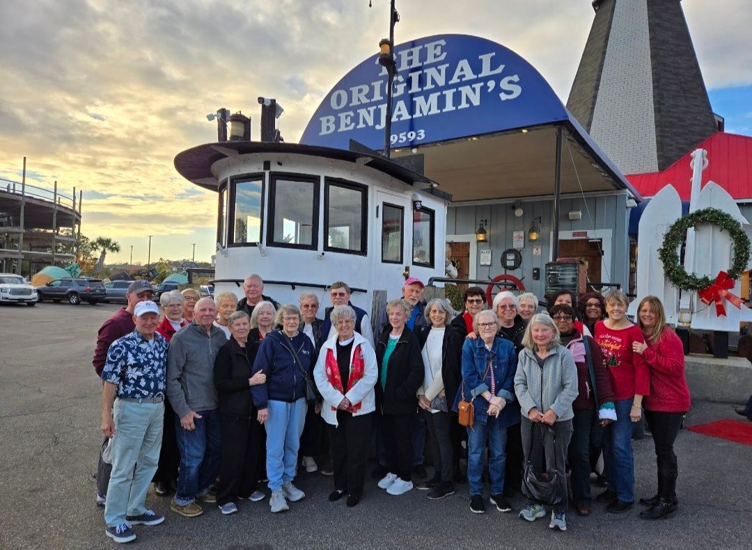 Group of people posing in front of 