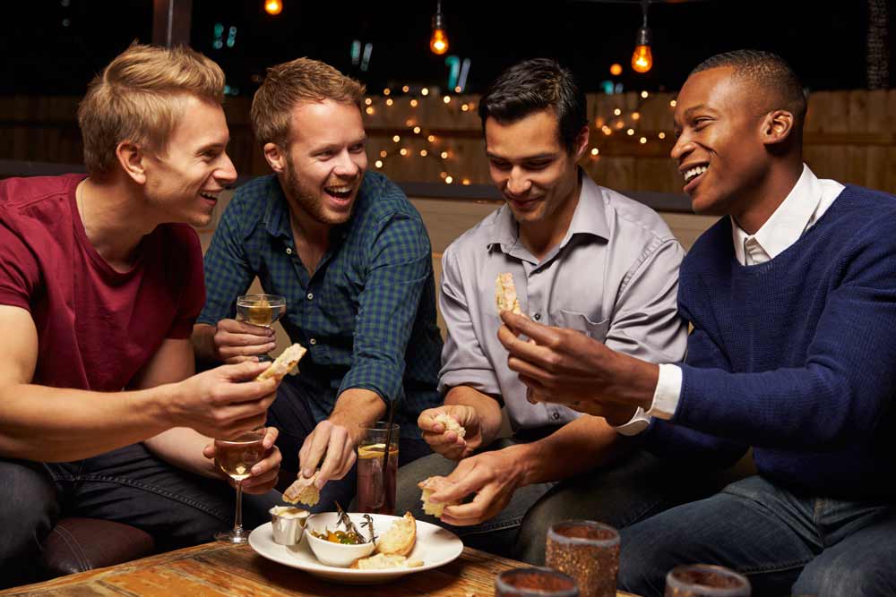 Birthday Parties — Men Eating Snacks In Bar in Jacksonville, FL