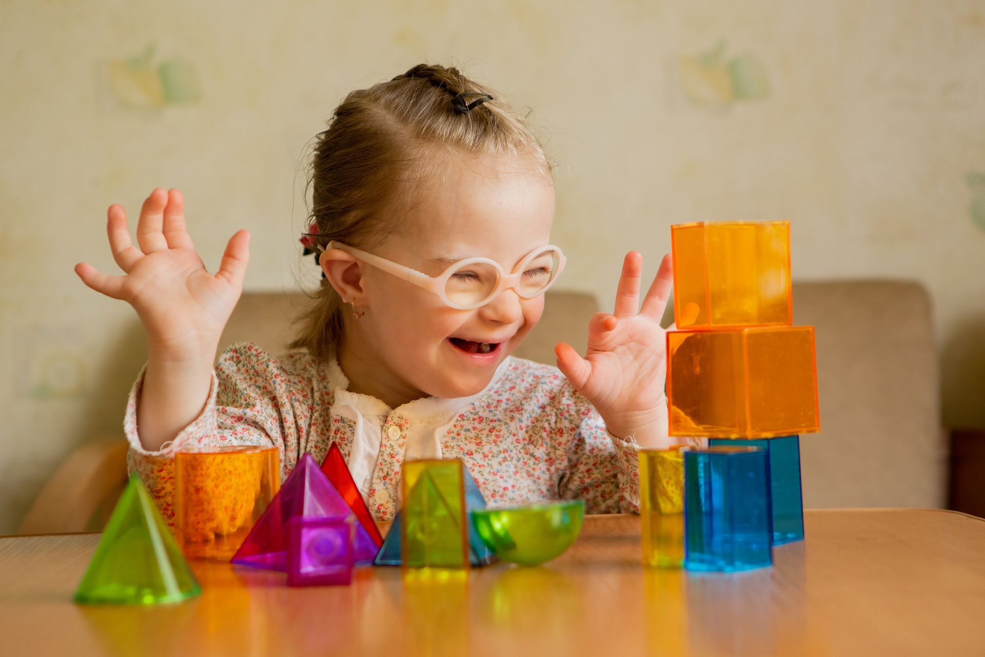 A special needs child playing with toys.