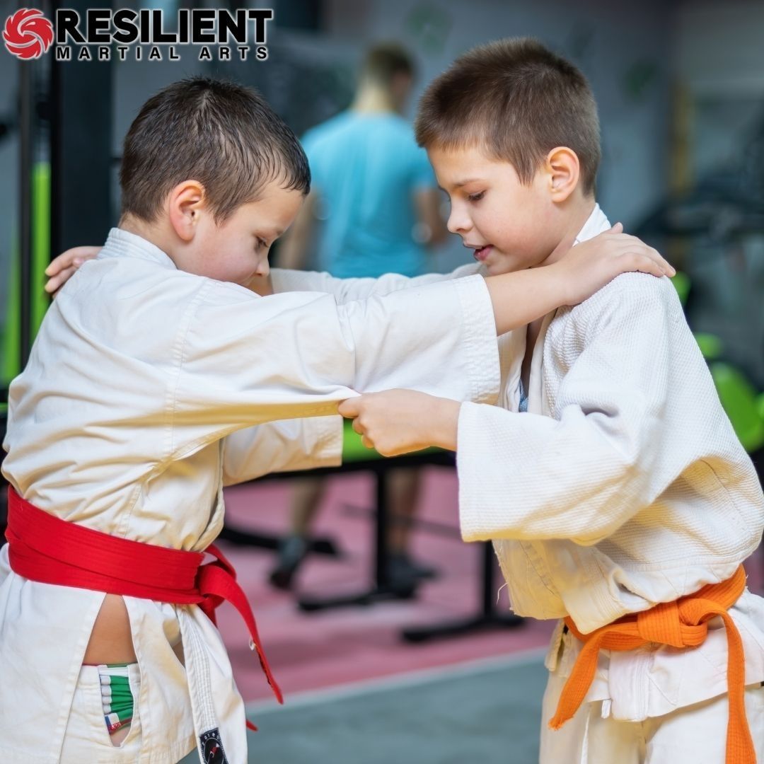 A boy and a girl are practicing taekwondo together.
