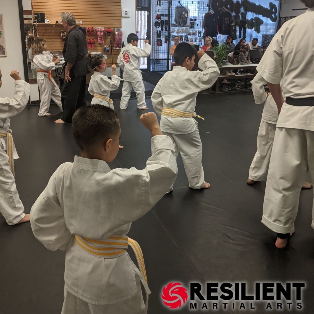 A young girl is practicing taekwondo in a gym.