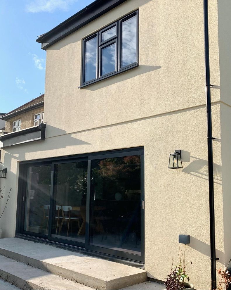 a house with a lot of windows and sliding glass doors