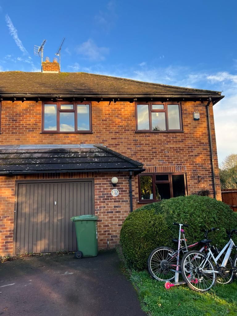 a brick house with bikes parked in front of it