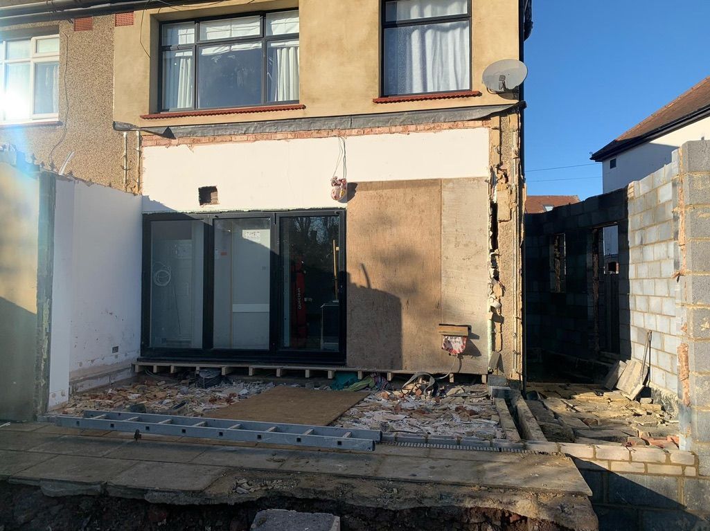 the back of a house that is being remodeled .