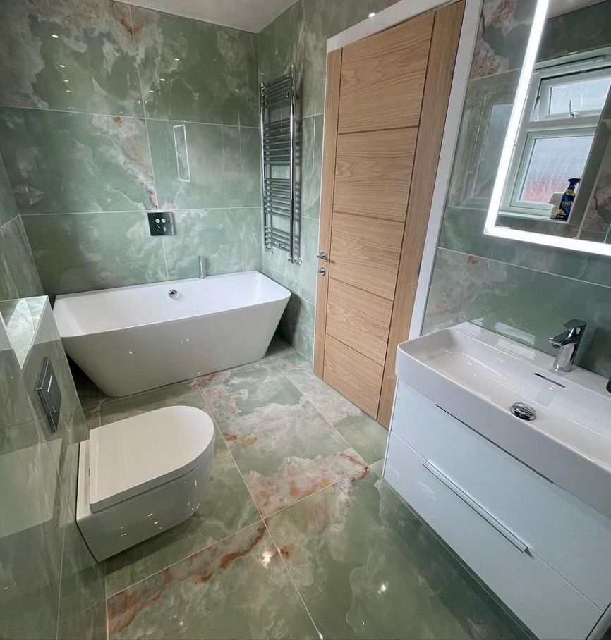 a modern bathroom with a featured bathtub , and sink and mirror .