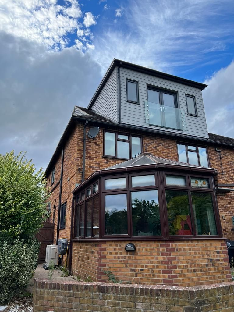 a large brick house with a new loft conversion