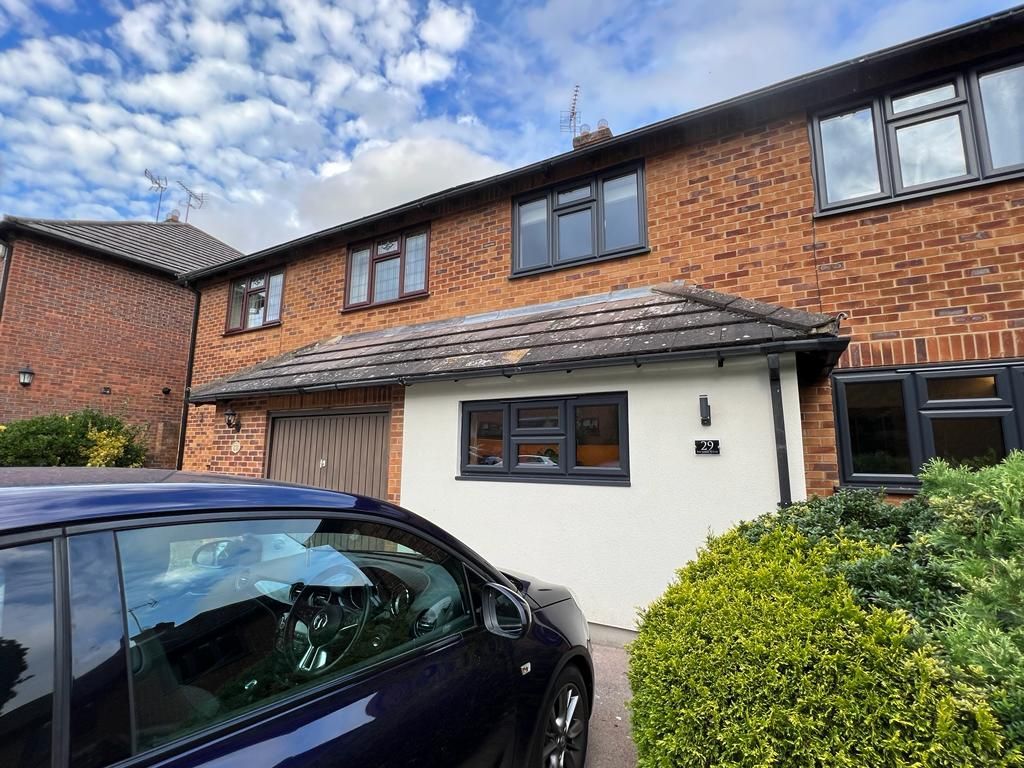 front of a brick house in Essex before renovations.
