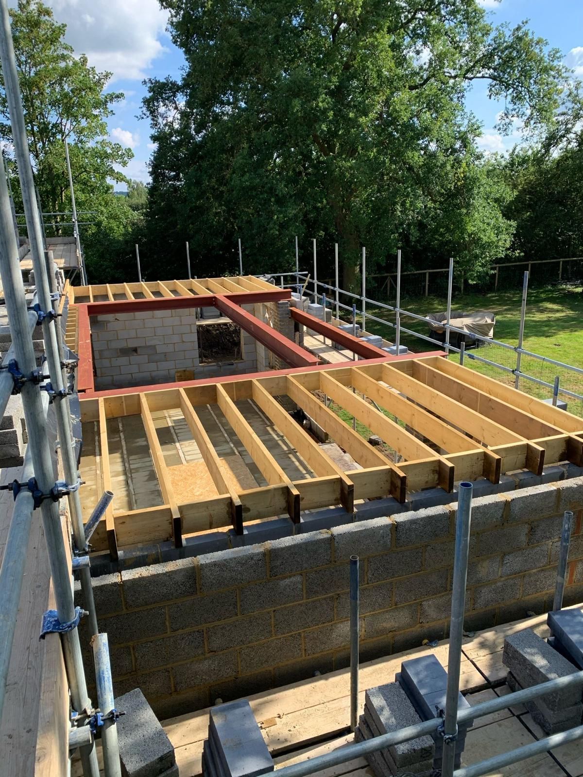 the roof of a building is being built with wooden beams .