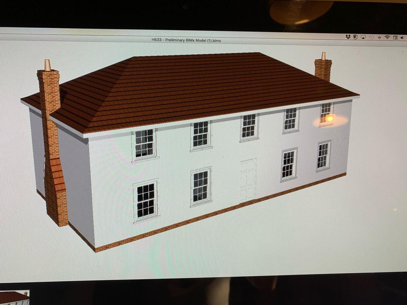 a computer screen shows a model of a house with a brown roof