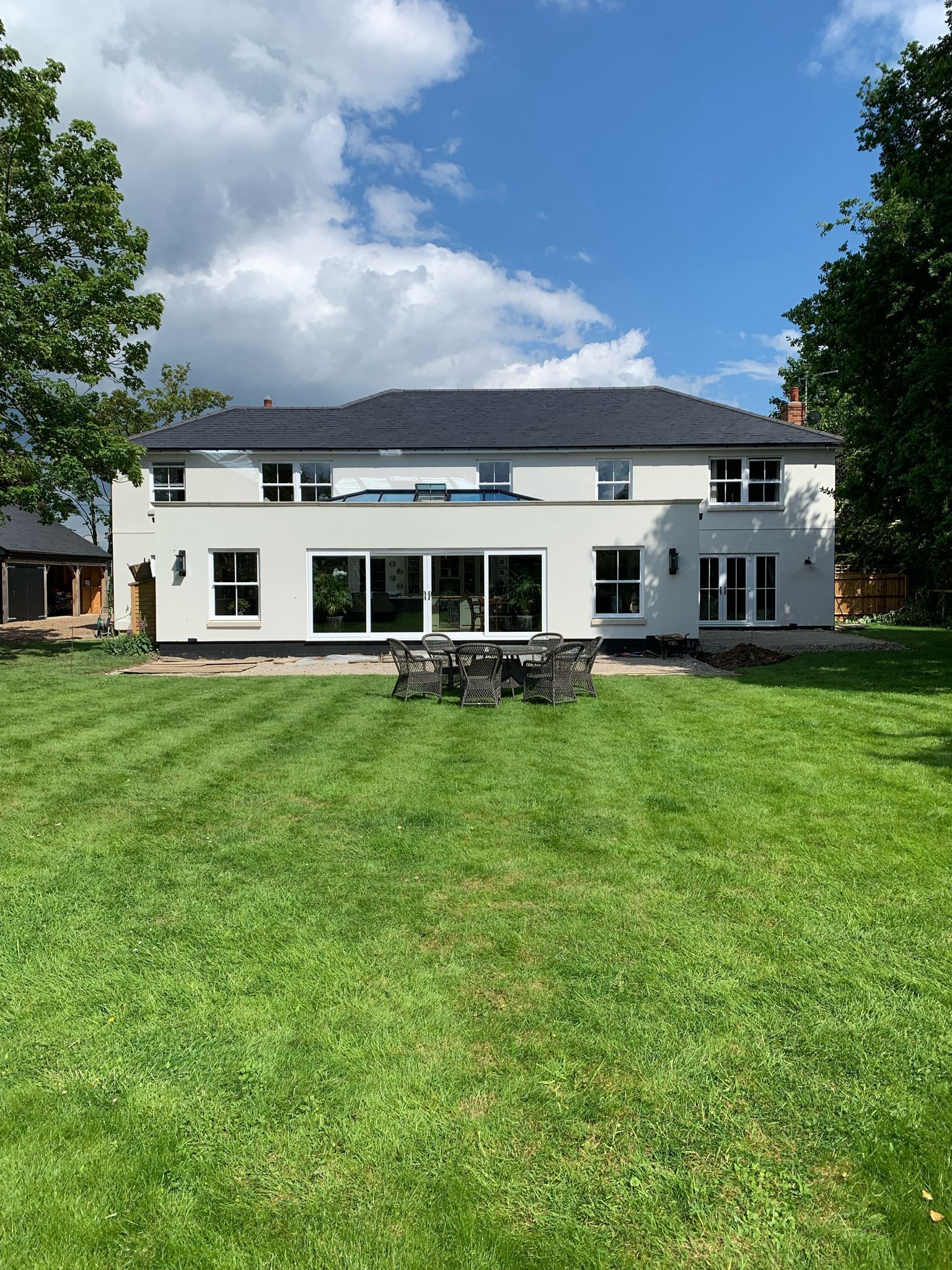 a large white house with a large lawn in front of it .