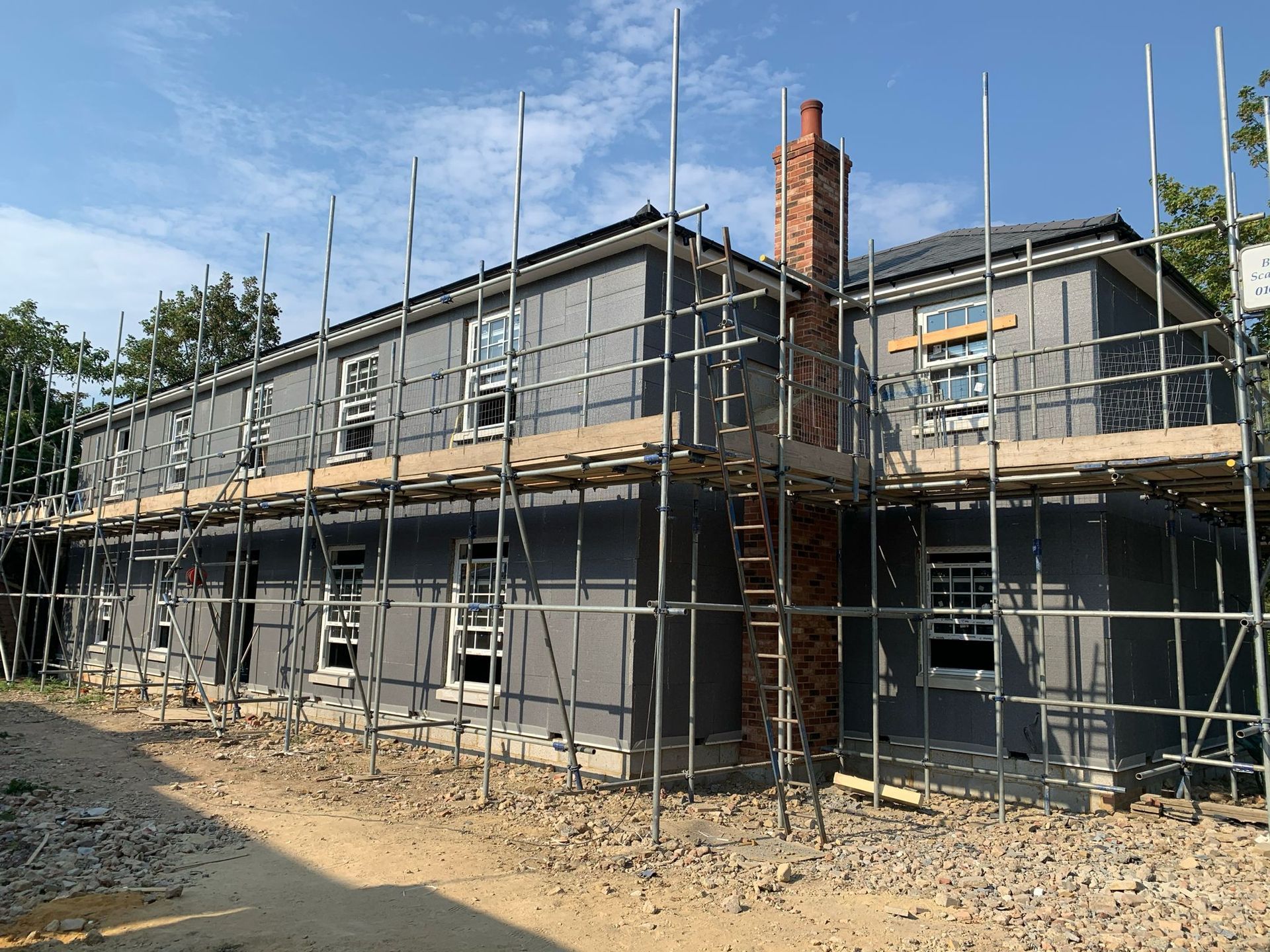 a large house is being built with scaffolding around it .