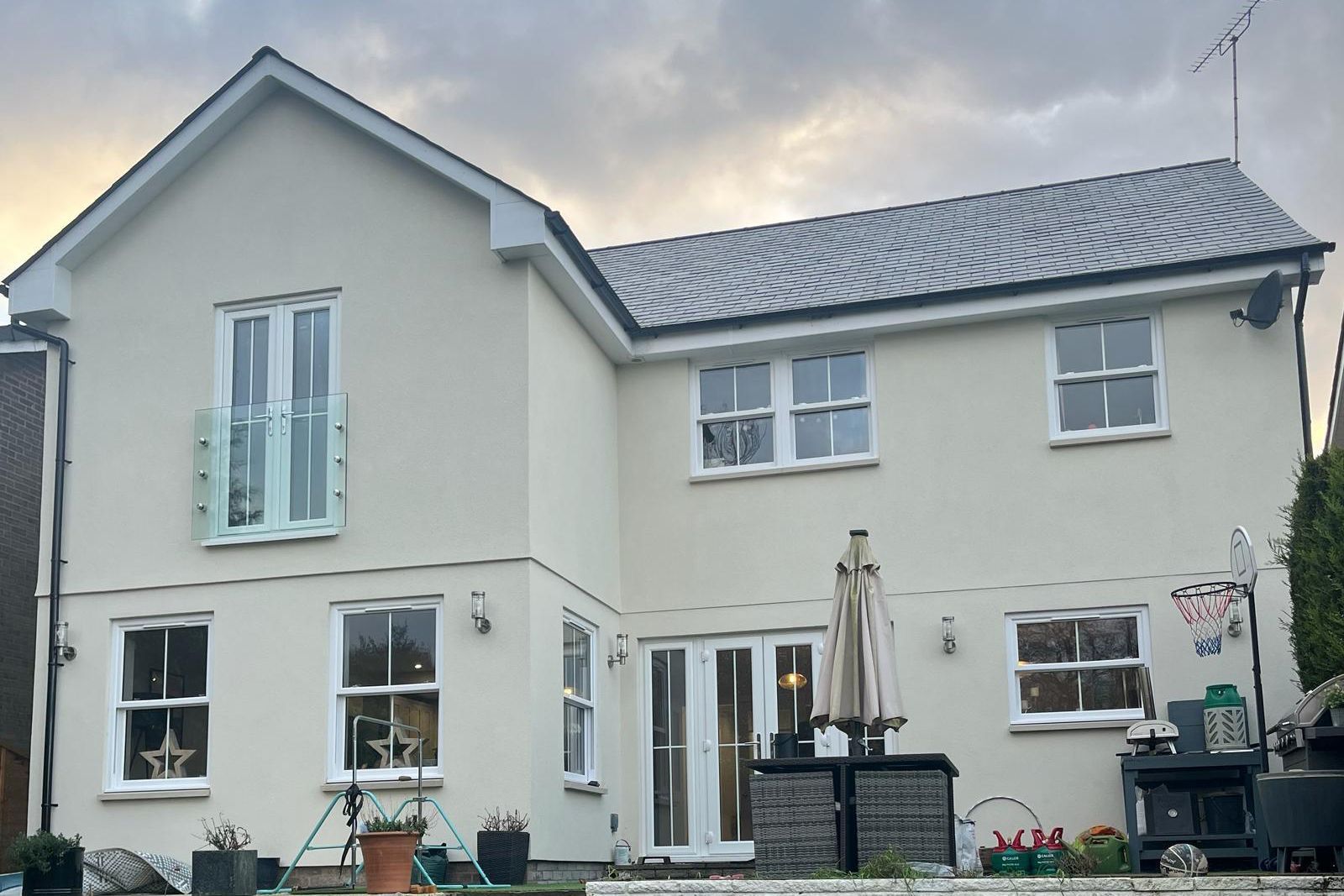 a large white house with a gray roof and a lot of windows