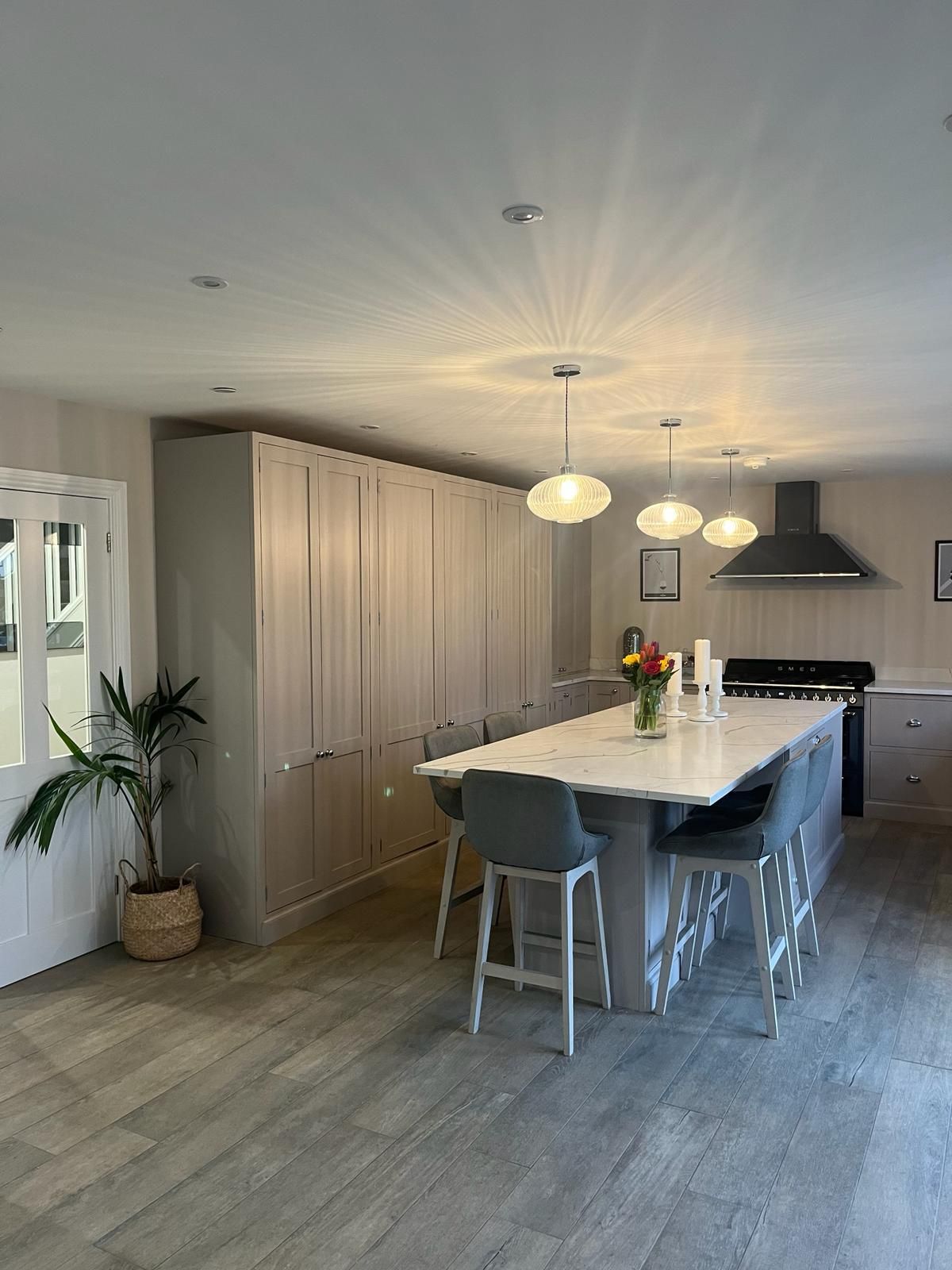 a large modern kitchen with a long table and chairs in it .