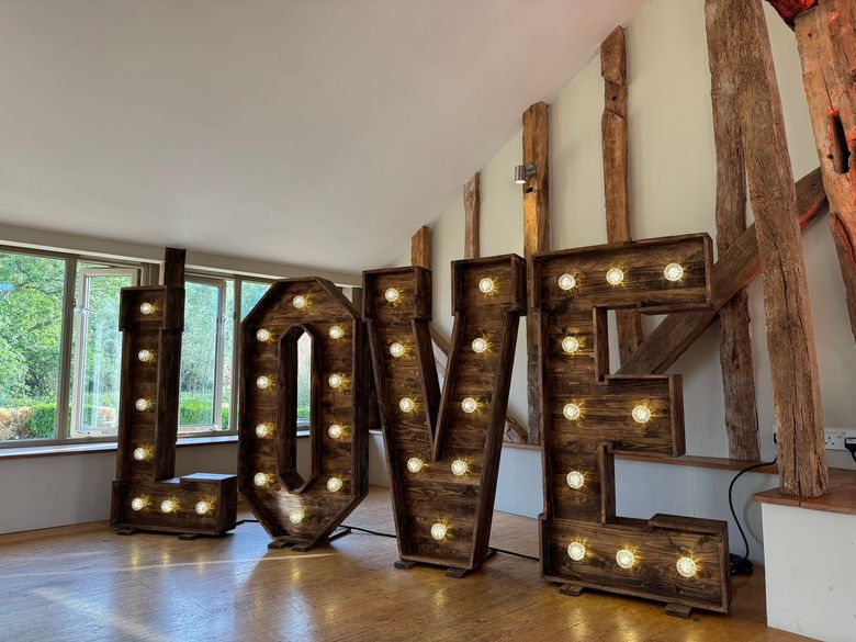 Large rustic wooden letters spelling 