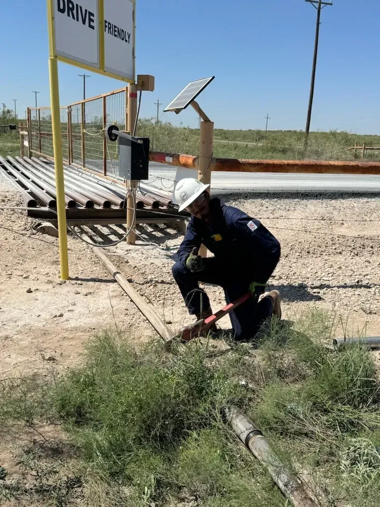 A man is kneeling down in front of a sign that says drive