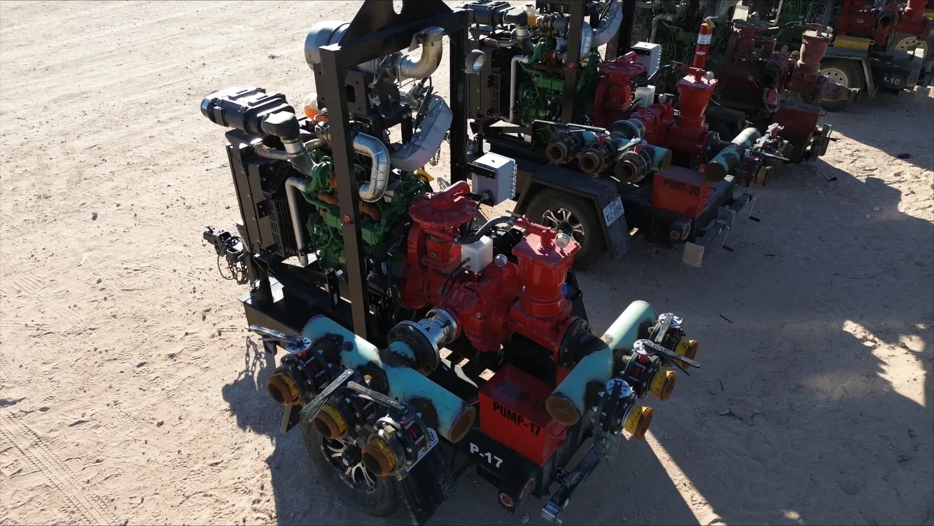 A bunch of machinery sitting on top of a dirt field