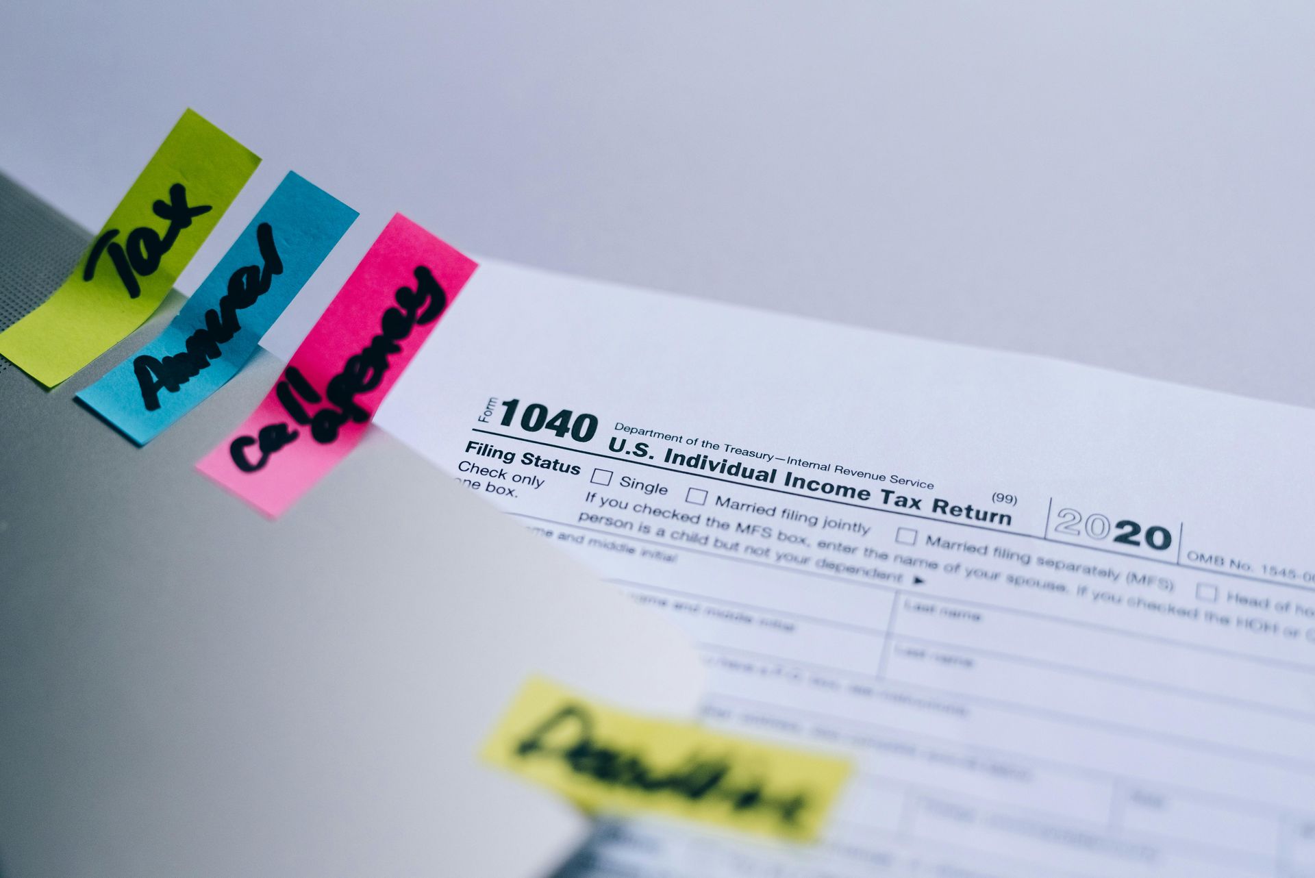 A close up of a tax form with sticky notes on it