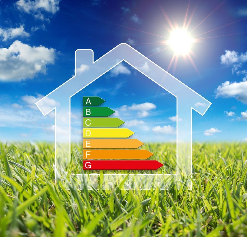 House outline with energy efficiency rating on green grass under a sunny blue sky.