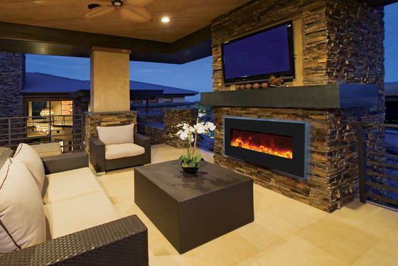 Outdoor patio with stone fireplace, TV, and seating.