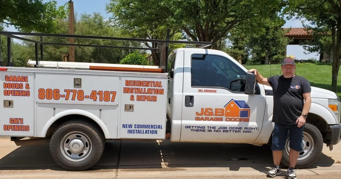 Man Standing Beside a Pick Up Truck