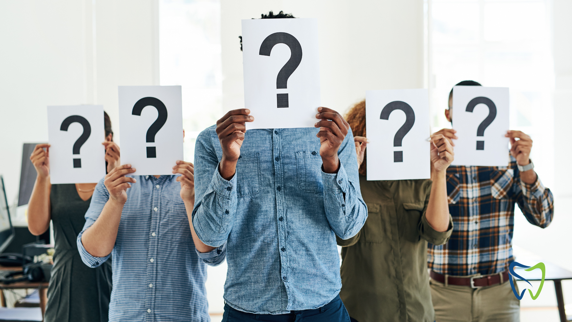 People holding signs with question marks.