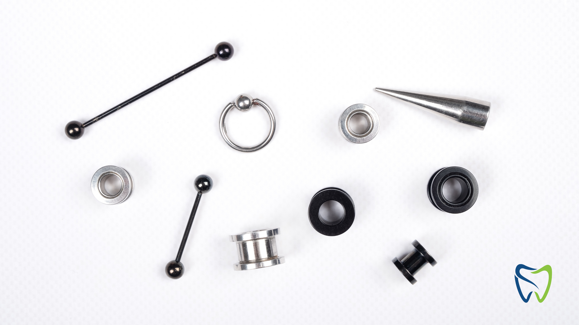 There are many different types of piercings on a white surface.